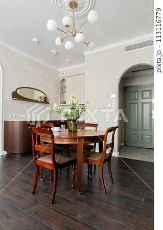 Dining room with table, chairs, chandelier in a hardwoodfloored building Dining room with table, chairs, chandelier in a hardwoodfloored building 113116779
