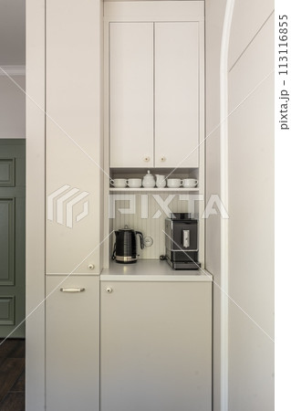 White cabinetry, coffee maker, and kettle in a kitchen White cabinetry, coffee maker, and kettle in a kitchen 113116855