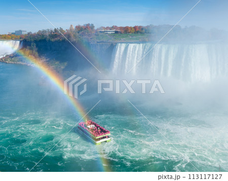 Niagara Falls. A pleasure boat with people near the huge famous waterfall. Niagara Falls. A pleasure boat with people near the huge famous waterfall. 113117127