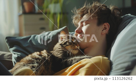 Caucasian man in casual clothes is sitting on the sofa with his cat in the living room. Caucasian man in casual clothes is sitting on the sofa with his cat in the living room. 113126262