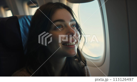 Caucasian woman sitting in airplane near window. 113126497