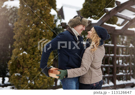 Man is hides box behind his back and going to give his woman a present on Valentine's Day, Christmas or New Year. Boyfriend and girlfriend dating romance. Husband gives gift to wife on her birthday. Man is hides box behind his back and going to give his woman a present on Valentine's Day, Christmas or New Year. Boyfriend and girlfriend dating romance. Husband gives gift to wife on her birthday. 113126647