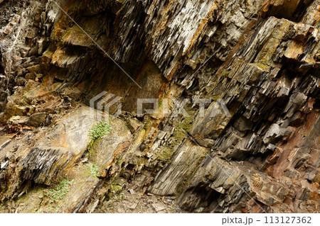 Diagonal rock material texture. Macro of old mountain stones pattern background. Carpathian mountains 113127362