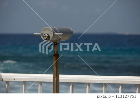 Beach guard telescope looking out towards sea views on surfer spot on Maldives 113127753