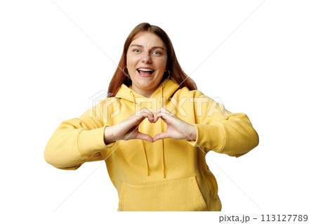 Attractive 30s brunette young woman feels happy and romantic shapes heart gesture expresses tender feelings poses against white background. Attractive 30s brunette young woman feels happy and romantic shapes heart gesture expresses tender feelings poses against white background. 113127789