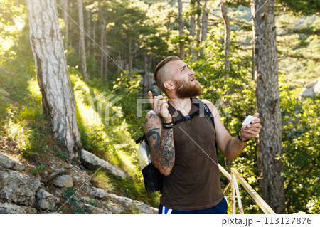 Bearded stylish hiker man using gps navigation for positioning at the mountain trail and thinks where to go. Technology concept 113127876