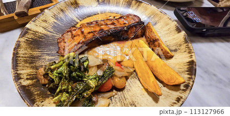 New york strip loin beef steak meat with mushroom sauce and potato wedges and salad plated on beautiful plate New york strip loin beef steak meat with mushroom sauce and potato wedges and salad plated on beautiful plate 113127966