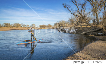 Expedition style winter stand up paddling on the South Platte RIver in eastern Colorado 113129289