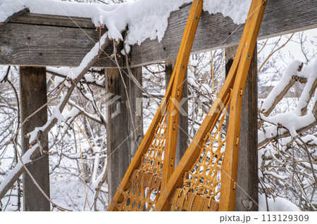 Detail of classic Huron snowshoes on a wooden deck 113129309
