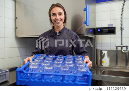 Woman with clean glasses preparing for event in restaurant 113129489