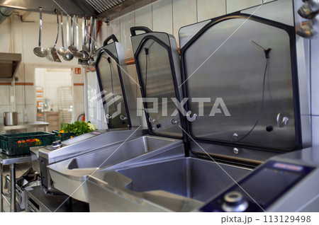 Industrial dishwasher in restaurant kitchen washing dishes 113129498