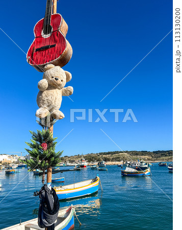 Fishing boats in the harbor of Marsaxlokk, Malta in a beautiful sunny day 113130200