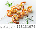 Grilled shrimps on white surface, garnished with fresh parsley and dill, offering a perfect blend of seafood and herbs 113131974