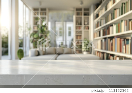 A white room with a wooden table and a shelf full of books 113132562