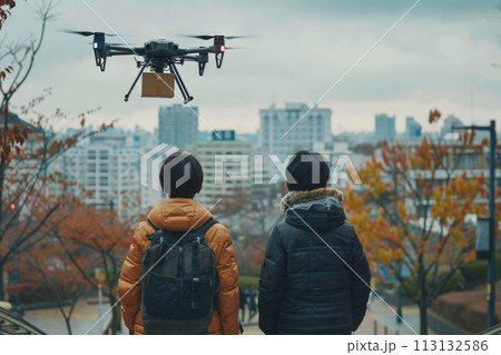 Two people are standing on a sidewalk, looking up at a drone flying overhead. logistic concept 113132586