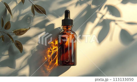 A bottle of liquor is sitting on a table in the sunlight 113133050