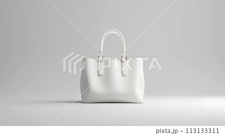 A white purse with a gold strap sits on a table in front of a plant 113133311