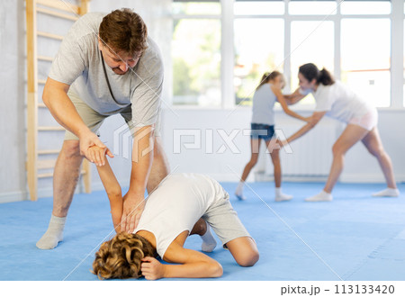 Parents and children during training and self-defense workout. Parents and children during training and self-defense workout. 113133420