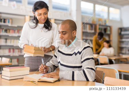 Adult people gaining skills at public library Adult people gaining skills at public library 113133439