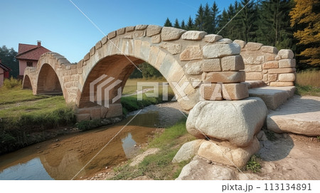 Medival stone bridge acrooss the stream 113134891