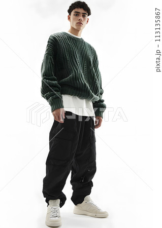 Man in green jersey and black active pants on white background 113135867