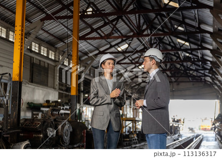 Supervisors and engineers wearing safety white helmet are inspecting station at train maintenance. Supervisors and engineers wearing safety white helmet are inspecting station at train maintenance. 113136317