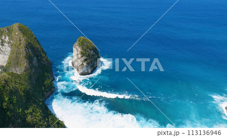 Turquoise ocean sea water white wave splashing deep blue sea. Bird eye view monster wave splash on rock. Tropical sea beach in summer seaside outdoor. Ocean island beautiful dramatic landscape. Turquoise ocean sea water white wave splashing deep blue sea. Bird eye view monster wave splash on rock. Tropical sea beach in summer seaside outdoor. Ocean island beautiful dramatic landscape. 113136946