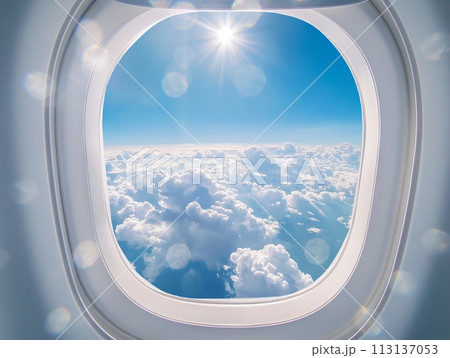 A breathtaking view of a cloud landscape seen from an airplane window, with the sun shining brightly above 113137053