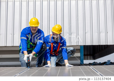 Engineer set installing and inspect standards of solar panels on roof of an industrial factory. Engineer set installing and inspect standards of solar panels on roof of an industrial factory. 113137404