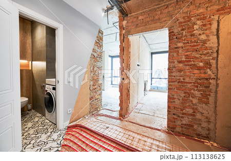 Comparison of old apartment before restoration and new renovated flat with modern interior design. Apartment with underfloor heating pipes and washing machine in bathroom before and after renovation. 113138625