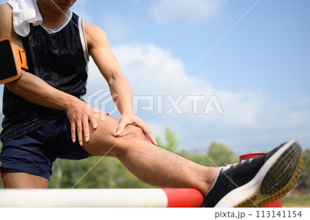 Male athlete having a knee injury during a running workout. Sport and health care concept 113141154
