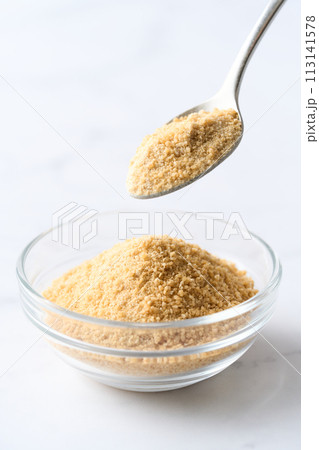 グラスの皿に盛り付けた甜菜糖 113141578