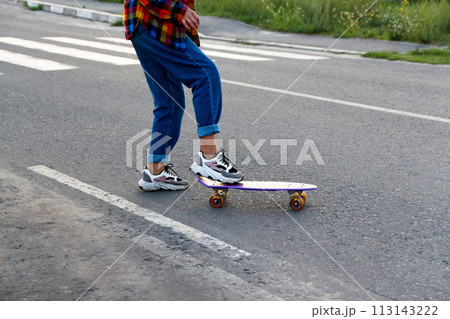 A rebellious teenager skateboarding through an urban crosswalk, defying traffic rules and adding an edgy vibe to street photography collections or articles on urban youth culture 113143222