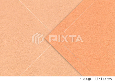 Color of the year 2024. Texture of peach fuzz paper background, half two colors with coral arrow, macro. Color of the year 2024. Texture of peach fuzz paper background, half two colors with coral arrow, macro. 113143769