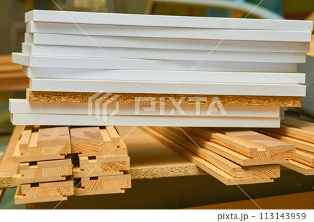 Sheets of plywood, boards, lumber stacked in rows in a carpentry in a warehouse 113143959