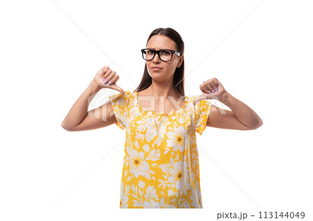 young serious brunette woman with glasses dressed in a summer orange T-shirt points at herself with 113144049
