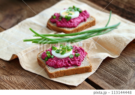 Beetroot mixed with goat cream cheese spreaded on whole grain bread. Beetroot mixed with goat cream cheese spreaded on whole grain bread. 113144448