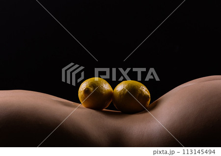 Lemon, natural vitamin c help skin whitening. Naked woman lying on her back with fruit located 113145494