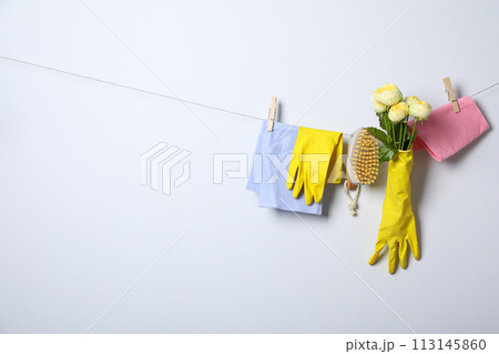 Rubber gloves with flowers on a rope 113145860