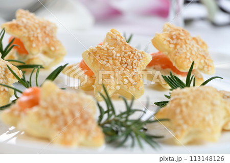 Puff pastry stars with salmon and cheese Puff pastry stars with salmon and cheese 113148126