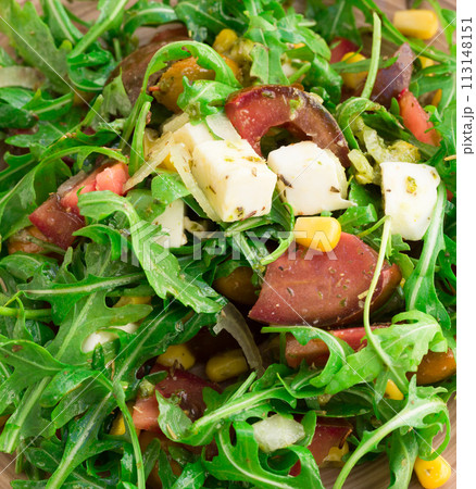 Mixed salad of arugula and fresh vegetables with sauce 113148151