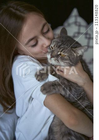 girl plays with a cat girl plays with a cat 113148820