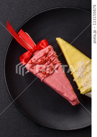Delicious sweet cheesecake with fruits covered with icing with a wooden stick Delicious sweet cheesecake with fruits covered with icing with a wooden stick 113150878