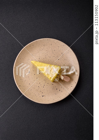 Delicious sweet cheesecake with fruits covered with icing with a wooden stick Delicious sweet cheesecake with fruits covered with icing with a wooden stick 113150902