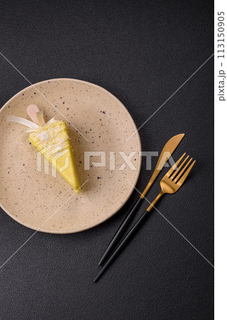 Delicious sweet cheesecake with fruits covered with icing with a wooden stick Delicious sweet cheesecake with fruits covered with icing with a wooden stick 113150905