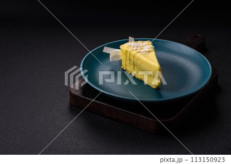 Delicious sweet cheesecake with fruits covered with icing with a wooden stick Delicious sweet cheesecake with fruits covered with icing with a wooden stick 113150923