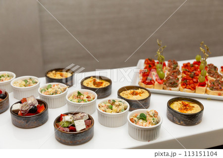 Buffet table with cold appetizers and salads. 113151104