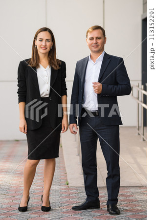 Young business partners look at camera making perfect corporate photo 113152291