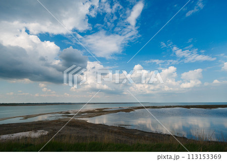 Sky and big clouds over firth with horizon line Sky and big clouds over firth with horizon line 113153369