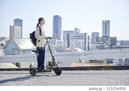 電動キックボードで移動をする日本人女性 113154830
